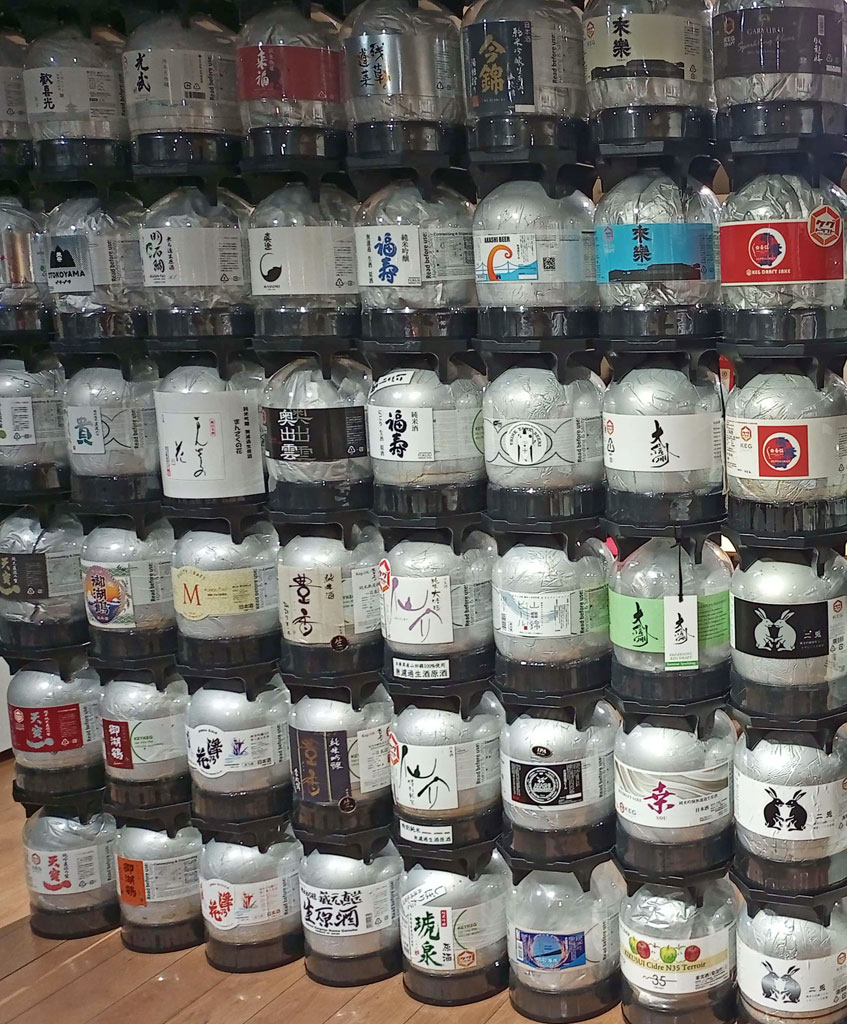 Diverse sake collection stacked in kegs ready for fresh shipping to Europe.